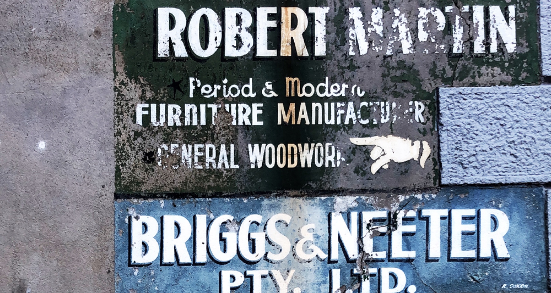 A column of weathered hand-painted ghost signs on a Melbourne CBD wall, including BRIGGS & NEETER PTY. LTD. and ROBERT MARTIN, PERIOD & MODERN FURNITURE MANUFACTURER.